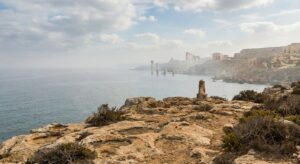 Rocky coastal landscape with ancient stone ruins overlooking the sea
