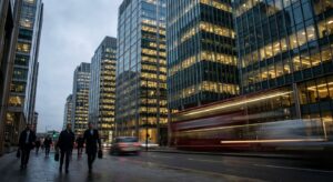 Exterior of large glass-clad corporate office buildings photographed at dusk.