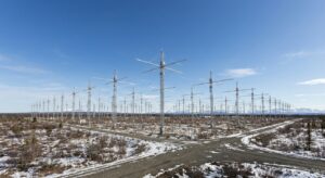A wide-angle view of the HAARP antenna array and surrounding landscape in Alaska, showing metal towers and open tundra.